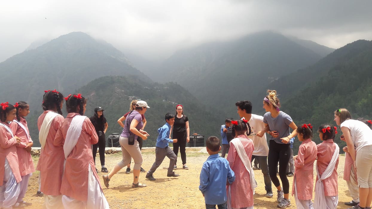 Interns with school children in the Himalayas